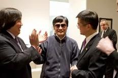 A handout photo from US Embassy Beijing Press office shows blind activist Chen Guangcheng (C) shaking hands with U.S. Ambassador to China Gary Locke (R), in Beijing, May 2, 2012.