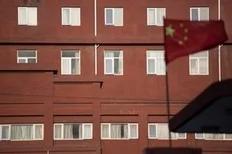 A Chinese flag flies before windows of the Chaoyang Hospital in Beijing where Chinese activist Chen Guangcheng was taken on May 2, 2012. Beijing pledged that the legal Chinese activist Chen Guangcheng -- who fled to the US embassy on April 22 -- and his family would be treated...