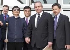 In this photo released by the US Embassy Beijing Press Office, blind lawyer Chen Guangcheng, front left, holds hands with U.S. Assistant Secretary of State for East Asia and Pacific Affairs Kurt Campbell, as U.S. Ambassador to China Gary Locke, back center, looks on, before leaving the U.S....