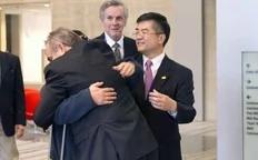 A handout photo from US Embassy Beijing Press office shows blind activist Chen Guangcheng (2nd L) hugging U.S. Assistant Secretary of State for East Asian and Pacific Affairs Kurt Campbell (front) as U.S. Ambassador to China Gary Locke (R) looks on, in Beijing, May 2, 2012.