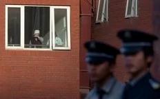 Two security guards stand at a gate as a woman looks out from a window at the Chaoyang Hospital in Beijing where Chinese activist Chen Guangcheng was taken on May 2, 2012. Beijing pledged that the legal Chinese activist Chen Guangcheng -- who fled to the US embassy on April 22 -- and...