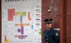 A security guard stands near a map beside a gate of the Chaoyang Hospital in Beijing where Chinese activist Chen Guangcheng was taken on May 2, 2012. Beijing pledged that the legal Chinese activist Chen Guangcheng -- who fled to the US embassy on April 22 -- and his family would be...