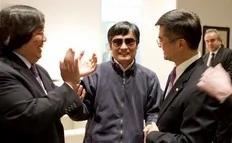 In this photo released by the US Embassy Beijing Press Office, blind lawyer Chen Guangcheng, center, holds hands with U.S. Ambassador to China Gary Locke, right, as U.S. State Department Legal Advisor Harold Koh, left, applauds, before leaving the U.S. embassy for a hospital in Beijing Wednesday...