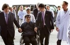 In this photo released by the US Embassy Beijing Press Office, blind lawyer Chen Guangcheng is wheeled into a hospital by U.S. Ambassador to China Gary Locke, right, and an unidentified official at left, in Beijing Wednesday May 2, 2012.