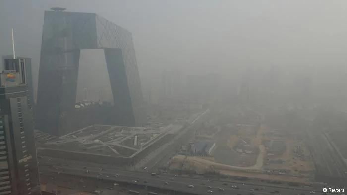 The China Central Television(CCTV) building is seen next to a construction site in heavy haze in Beijing
