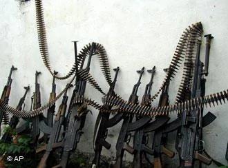 Kalashnikov assault rifles and a couple of heavy machine guns are lines up against a wall at one of Mogadishu four open-air markets, Monday, July9,2001. As the United Nations discusses what to do about the world