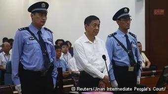 Disgraced Chinese politician Bo Xilai stands trial inside the court in Jinan, Shandong province August22,2013, in this photo released by Jinan Intermediate People