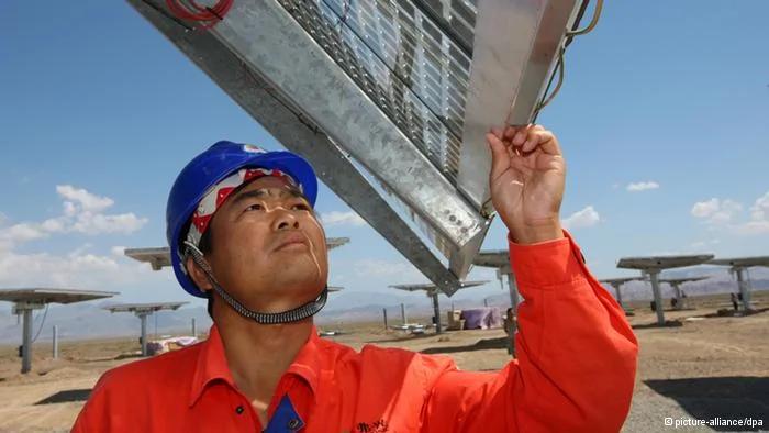 Chinese workers check and test solar panels at Fuguang photovoltaic power station in Hami city, northwest Chinas Xinjiang Uygur Autonomous Region,6 August2012. China, the biggest supplier of solar power panels, quadrupled a domestic installation goal for solar energy projects to21 gigawatts by2015 to help absorb the excess supply of panels and support prices. The target includes1 gigawatt of solar-thermal power plants, said Shi Lishan, deputy director of the administrations renewable energy division. China had planned5 gigawatts of capacity in the five years through2015 and20 gigawatts by2020.