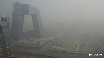 The China Central Television(CCTV) building is seen next to a construction site in heavy haze in Beijing