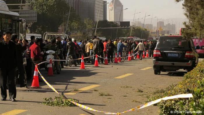 GettyImages187060123    People stand on a street after an explosion outside a provincial headquarters of China