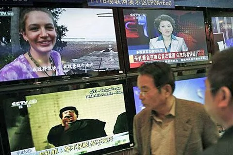 2011年3月23号在中国广播电视信息网络博览会上，中国民众观看利比亚领导人卡扎菲讲话的新闻(资料照)