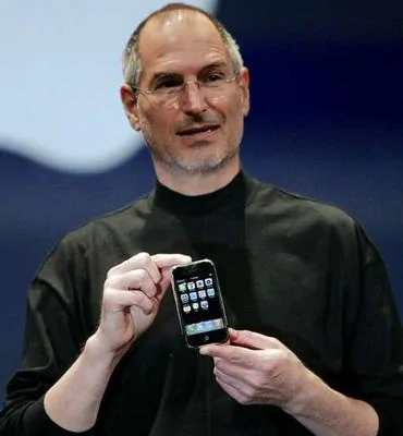 Apple CEO Steve Jobs holds the new iPhone.