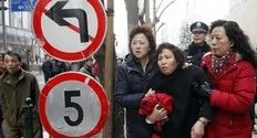 A woman (C) is arrested by unidentified women, believed to be plainclothes police, after internet social networks called to join a "Jasmine Revolution" protest in front of the Peace Cinema in downtown Shanghai February 20, 2011. Police dispersed scores of people who gathered in central...