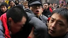 Plainclothes policemen drag a protester away after internet social networks called for a "Jasmine Revolution" protest in front of a Mcdonald's restaurant in central Beijing February 20, 2011. Chinese President Hu Jintao called on Saturday for stricter government management of the...
