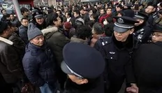 Police walk around people after social networks called to join a "Jasmine Revolution" protest in front of the Peace Cinema in downtown Shanghai February 20, 2011. Police dispersed scores of people who gathered in central Beijing and Shanghai on Sunday after calls spread online across...
