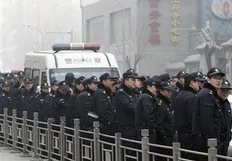 Chinese police officers stand guard near a McDonald's restaurant which was a planned protest site for "Jasmine Revolution" in Beijing, China, Sunday, Feb. 20, 2011. Jittery Chinese authorities staged a concerted show of force Sunday to squelch a mysterious online call for a "Jasmine...