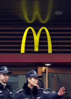 Policemen try to disperse a crowd that had gathered outside a Mcdonald's restaurant after internet social networks called for a "Jasmine Revolution" protest in central Beijing February 20, 2011. Chinese President Hu Jintao called on Saturday for stricter government management of the...