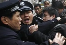A man is arrested by police after internet social networks called to join a "Jasmine Revolution" protest in front of the Peace Cinema in downtown Shanghai February 20, 2011. Police dispersed scores of people who gathered in central Beijing and Shanghai on Sunday after calls spread...