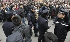 Chinese police officers urge people and journalist to leave an area in front of a McDonald's restaurant which was a planned protest site for "Jasmine Revolution" in Beijing, China, Sunday, Feb. 20, 2011. Jittery Chinese authorities staged a concerted show of force Sunday to squelch a...