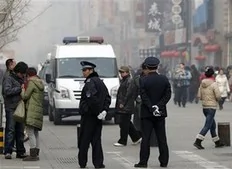 Chinese police officers stand watch near a McDonald's restaurant which was a planned protest site for "Jasmine Revolution" in Beijing, China, Sunday, Feb. 20, 2011. Jittery Chinese authorities staged a concerted show of force Sunday to squelch a mysterious online call for a "Jasmine...