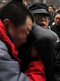 Plainclothes policemen drag a protester away after internet social networks called for a "Jasmine Revolution" protest outside a Mcdonald's restaurant in central Beijing February 20, 2011. Chinese President Hu Jintao called on Saturday for stricter government management of the Internet...