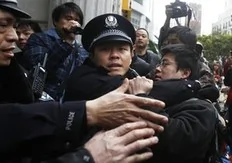 A man is arrested by police after internet social networks called to join a "Jasmine Revolution" protest in front of the Peace Cinema in downtown Shanghai February 20, 2011. Police dispersed scores of people who gathered in central Beijing and Shanghai on Sunday after calls spread...