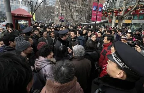 上海的警察驱赶计划在一家电影院门前抗议的人们