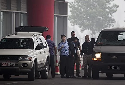 賴昌星7月23日被遣返回中國，押送他的加拿大警官(右中)在北京國際機場與中國警官交談