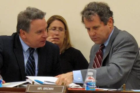 布郎参议员(右)和史密斯众议员在听证会上交谈 