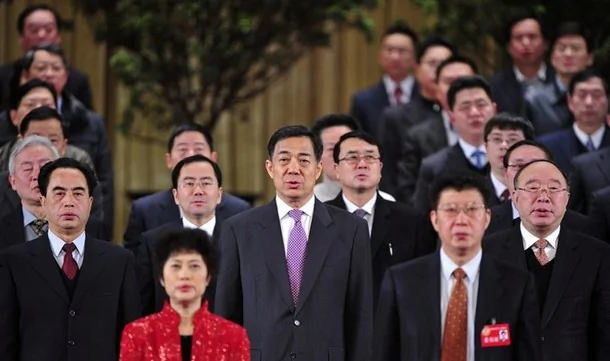 China's former Chongqing Municipality Communist Party Secretary Bo Xilai (C) and former Deputy Mayor of Chongqing Wang Lijun (Bo's L) sing the national anthem during a session of the Chinese People's Political Consultative Conference (CPPCC) of the Chongqing Municipal Committee, in Chongqing municipality, January 7, 2012. On Feb. 6, Wang fled to a U.S. consulate in an apparent asylum attempt after he confronted Bo, sources say, with evidence implicating the wife of Bo, Gu Kailai, in the death of British businessman Neil Heywood, once a friend of the Bo family. Wang spent about 24 hours inside the consulate before being collected by Chinese central government authorities. He could now face treason charges. The rupture in his relations with Bo hastened the end of the career of a police officer whose methods in Chongqing, China's biggest municipality, were decried by critics as brutal. Picture taken January 7, 2012.