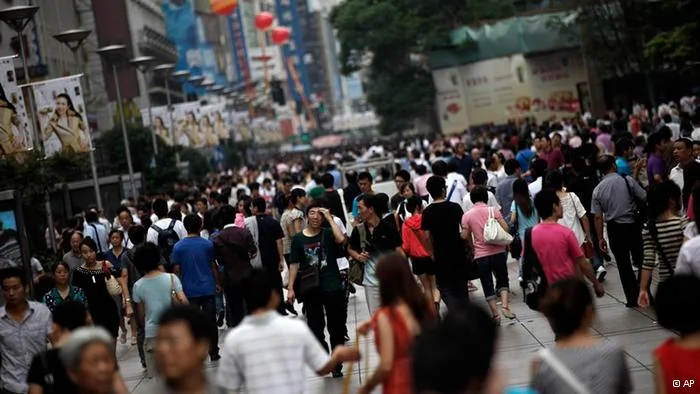 People walk on a shopping street on the Mid-Autumn Festival holiday, Monday, Sept.12,2011 in Shanghai, China. The Mid-Autumn Festival, also known as Moon Festival, falling on the15th day of the8th month of the lunar calendar will take place on Sept.12 this year.(AP Photo/Eugene Hoshiko)
