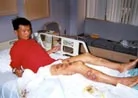 7/30/2001發表.法輪功學員覃永潔被中國警察用燒紅的鐵條烙傷十三處