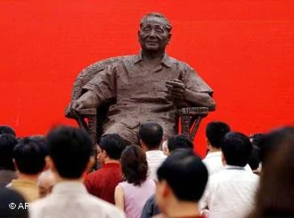 Visitors look at the bronze statue of Deng Xiaoping which was installed to celebrate the100th anniversary of his birth, on Saturday, Aug.21,2004 in Guangan, Deng's hometown, southwest China. Deng, former leader of China from1978 to1989, was born Aug.22,1904, in Sichuan Province, China, and several official events will be carried out for the anniversary nationwide.(AP Photo/Eugene Hoshiko)