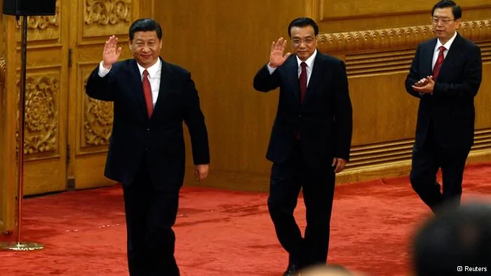 China's new Politburo Standing Committee members(from L to R) Xi Jinping, Li Keqiang and Zhang Dejiang wave as they arrive to meet with the press at the Great Hall of the People in Beijing, November15,2012. China's ruling Communist Party unveiled its new leadership line-up on Thursday to steer the world's second-largest economy for the next five years, with Vice President Xi Jinping taking over from outgoing President Hu Jintao as party chief. tREUTERS/Carlos Barria(CHINA- Tags: POLITICS)