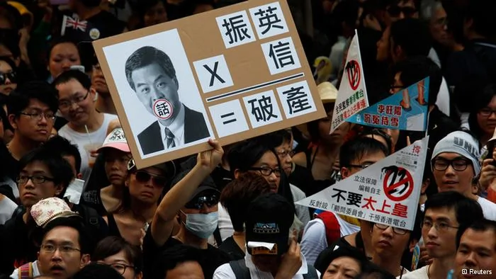 A protester holds a sign mocking new leader Leung Chun-ying during a demonstration urging him to step down in Hong Kong July1,2012, during the15th anniversary of the territory's handover to China. Leung was sworn into office on Sunday by Chinese President Hu Jintao for a five-year term in which he will confront challenges ranging from human rights to democracy after a tumultuous year of transition and protest. REUTERS/Bobby Yip(CHINA- Tags: POLITICS ANNIVERSARY CIVIL UNREST)