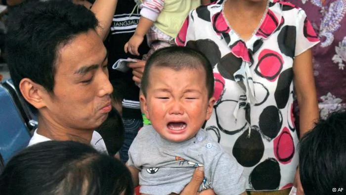 A child cries as he waits for ultrasonic scan to detect for problems related to consuming tainted milk formula at a hospital in Shijiazhuang, northern China's Hebei province, Thursday, Sept.18,2008. Chinese police arrested12 more people Thursday as a fourth death was reported in a scandal involving tainted milk powder that has sickened more than6,200 babies.(AP Photo/Ng Han Guan)