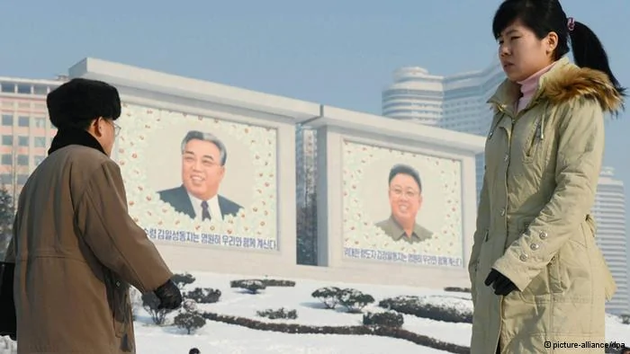 ©Kyodo/MAXPPP-11/12/2012; PYONGYANG, North Korea- People pass by huge portraits of the late former North Korean leaders Kim Il Sung(L) and Kim Jong Il in Pyongyang, North Korea, on Dec.10,2012.(Kyodo)