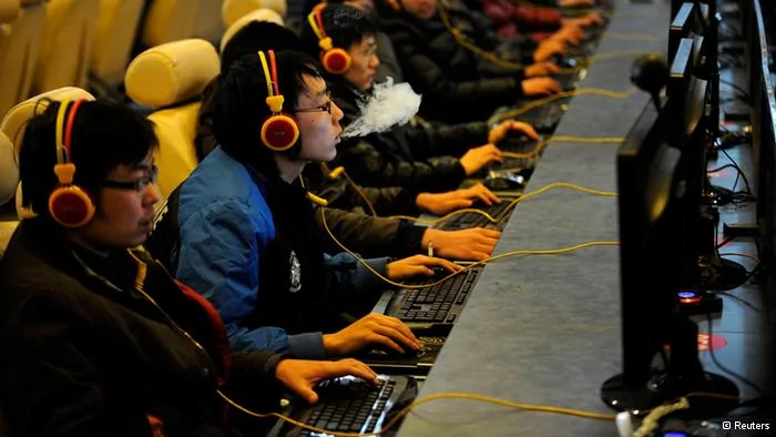 A man smokes while using a computer at an Internet cafe in Taiyuan, Shanxi province in this December30,2010 file photo. As China prepares for a generational power shift in the next two weeks, a similar shift is happening online that is testing the limits and displaying the evolution of China's legions of state-directed censors. Since its launch three years ago, Weibo, China's version of Twitter, has become the country's water cooler, a place where nearly300 million Internet users opine on everything from Korean soap operas to China's latest political intrigue. REUTERS/Stringer/Files(CHINA- Tags: POLITICS SCIENCE TECHNOLOGY) CHINA OUT. NO COMMERCIAL OR EDITORIAL SALES IN CHINA