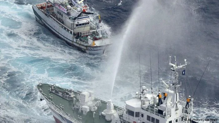 A Japan Coast Guard patrol boat sprays water against a Taiwanese fishing boat, top, near disputed islands, called Senkaku in Japan and Diaoyu in China, in the East China Sea, Tuesday, Sept.25,2012. Japanese coast guard ships fired water cannon to push back Taiwanese vessels Tuesday in the latest confrontation over a group of the tiny islands, as the main contenders, China and Japan, opened talks in a diplomatic effort to tamp down tensions.(AP Photo/Kyodo News) JAPAN OUT, MANDATORY CREDIT, NO LICENSING IN CHINA, FRANCE, HONG KONG, JAPAN AND SOUTH KOREA
