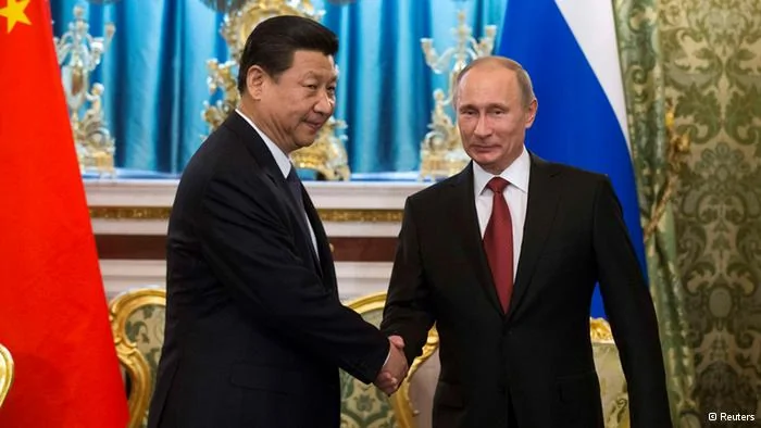 Russia's President Vladimir Putin(R) shakes hands with his Chinese counterpart Xi Jinping during a meeting at the Kremlin in Moscow March22,2013. REUTERS/Alexander Zemlianichenko/Pool(RUSSIA- Tags: POLITICS)