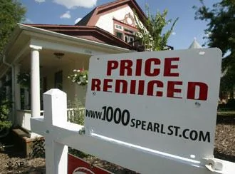 A sign to inform prospective buyers that the price has been reduced sits on top of the sale sign outside a single-family home in south Denver on Sunday, Sept.2,2007. The asking price for the home was listed at$550,000. The U.S. economy will slow sharply this year and fall behind growth rates in most of the world, according to forecasts in a U.N. report released Wednesday, Sept.5,2007. Woes in the housing market will drag U.S. gross domestic product for2007 to a modest2 percent growth, compared with3.3 percent last year, the U.N. Conference on Trade and Development said in its flagship annual report.(AP Photo/David Zalubowski)