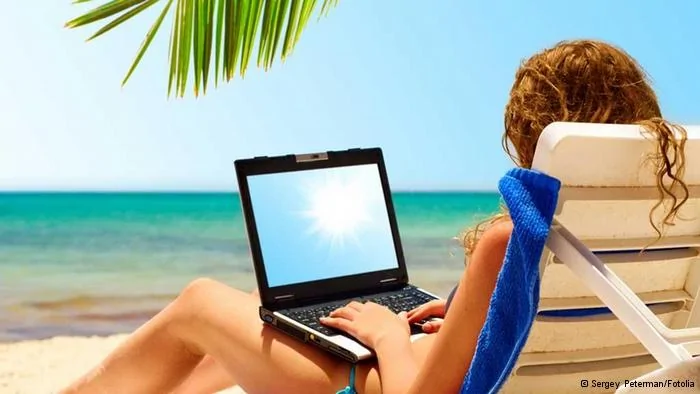 surfing on the beach. Laptop display is cut with clipping path© Sergey Peterman#16593145
