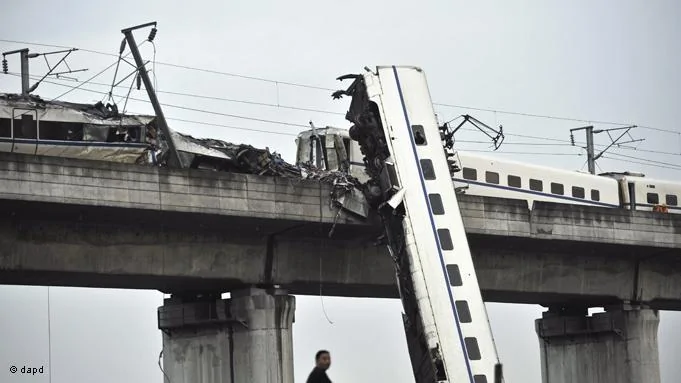 A man sits by the wreckage of a train accident in Wenzhou in east China's Zhejiang province, Sunday, July24,2011. A Chinese bullet train crashed into another high-speed train that had stalled after being struck by lightning Saturday in eastern China, causing four carriages to fall off a viaduct.(Foto:AP/dapd) CHINA OUT