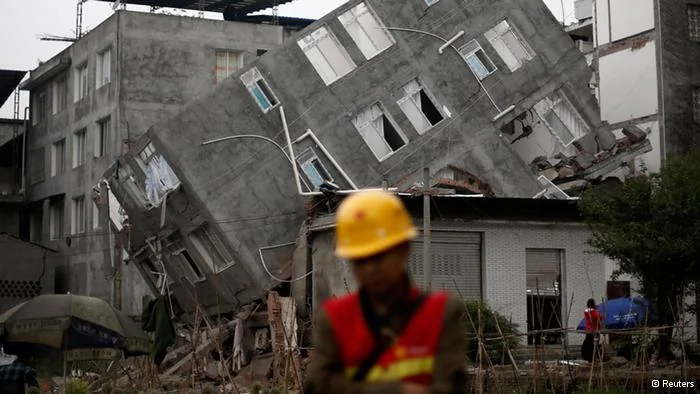 A rescuer walks in front of a damaged building after Saturday's earthquake in Lingguan town of Baoxing county, Sichuan province April22,2013. Rescuers struggled to reach a remote, rural corner of southwestern China on Sunday as the toll of the dead and missing from the country's worst earthquake in three years climbed to208 with almost1,000 serious injuries. The6.6 magnitude quake struck in Lushan county, near the city of Ya'an in the southwestern province of Sichuan, close to where a devastating7.9 quake hit in May2008, killing70,000. REUTERS/Aly Song(CHINA- Tags: DISASTER ENVIRONMENT TPX IMAGES OF THE DAY)