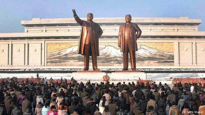 This picture taken by North Korea's official Korean Central News Agency on December17,2012 shows crowds of people visiting the Mansu Hill in Pyongyang before statues of late President Kim Il-Sung and leader Kim Jong-Il on the first anniversary of leader Kim Jong-Il's death. North Korea on December17 mourned the death one year ago of leader Kim Jong-Il, with its rocket scientists taking pride of place at a mass memorial ceremony led by his son and successor Kim Jong-Un. AFP PHOTO/ KCNA via KNS---EDITORS NOTE--- RESTRICTED TO EDITORIAL USE- MANDATORY CREDIT AFP PHOTO/ KCNA VIA KNS- NO MARKETING NO ADVERTISING CAMPAIGNS- DISTRIBUTED AS A SERVICE TO CLIENTS(Photo credit should read KNS/AFP/Getty Images)
