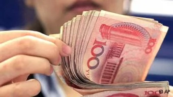 In this photo taken on Aug.25,2010, a bank clerk counts Chinese100 Yuan notes in Shanghai. China's currency advanced to a fresh high against the U.S. dollar for the second straight day on Tuesday, Sept.14,2010 as U.S. lawmakers prepared for hearings on Beijing's foreign exchange policies.(AP Photo/Eugene Hoshiko)