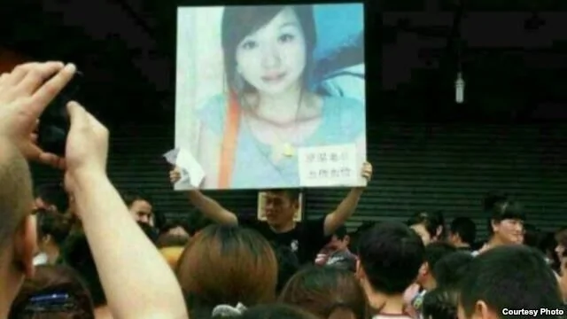 袁利亚的亲属朋友在京温商场外举牌喊冤。(微博图片)