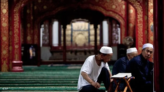 Chinese Hui Muslim men read the Quran, Islam's holy book, on the first day of the Muslim holy month of Ramadan at the Niujie Mosque in Beijing Monday, Aug.1,2011.(AP Photo/Andy Wong)
