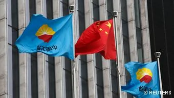 A Chinese national flag flutters between PetroChina's flags at PetroChina's headquarters in Beijing August28,2013. The Hong Kong-listed shares of China's dominant oil producer PetroChina Co Ltd and its natural gas distribution arm Kunlun Energy tumbled on Wednesday after they said several senior executives at the group were being investigated over alleged wrongdoing. REUTERS/Kim Kyung-Hoon(CHINA- Tags: BUSINESS)