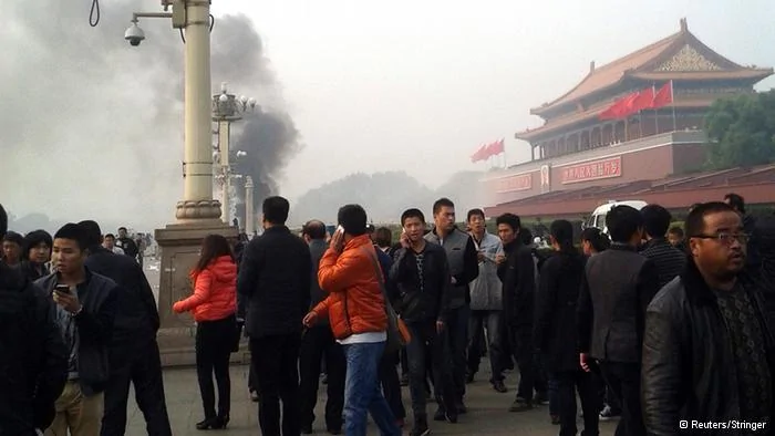 People walk along the sidewalk of Chang'an Avenue as smoke raises in front of the main entrance of the Forbidden City at Tiananmen Square in Beijing
People walk along the sidewalk of Chang'an Avenue as smoke raises in front of the main entrance of the Forbidden City at Tiananmen Square in Beijing October28,2013. Five people were killed and dozens injured on Monday, the government said, when a car ploughed into pedestrians and caught fire in Beijing's Tiananmen Square, the site of1989 pro-democracy protests bloodily suppressed by the military. Chinese Foreign Ministry spokeswoman Hua Chunying, asked whether the government believed the incident was a terror attack, said she did not know the specifics of the case and declined further comment. REUTERS/Stringer(CHINA- Tags: DISASTER POLITICS) CHINA OUT. NO COMMERCIAL OR EDITORIAL SALES IN CHINA